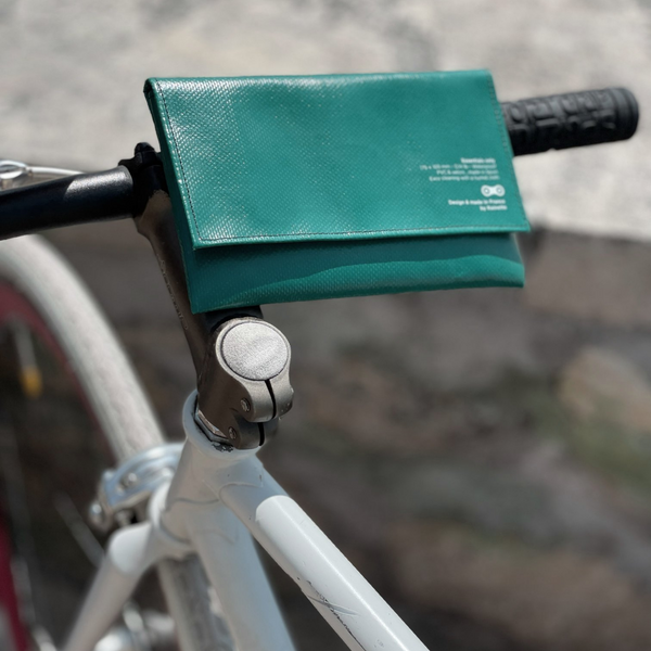 grüne wetterfeste mini Fahrradtasche made in France am Lenker eines Fahrrads befestigt